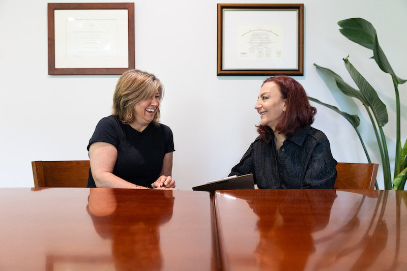 A woman is sitting down and having a consultation with a physician to discus hormone therapy near Rocky River, OH.