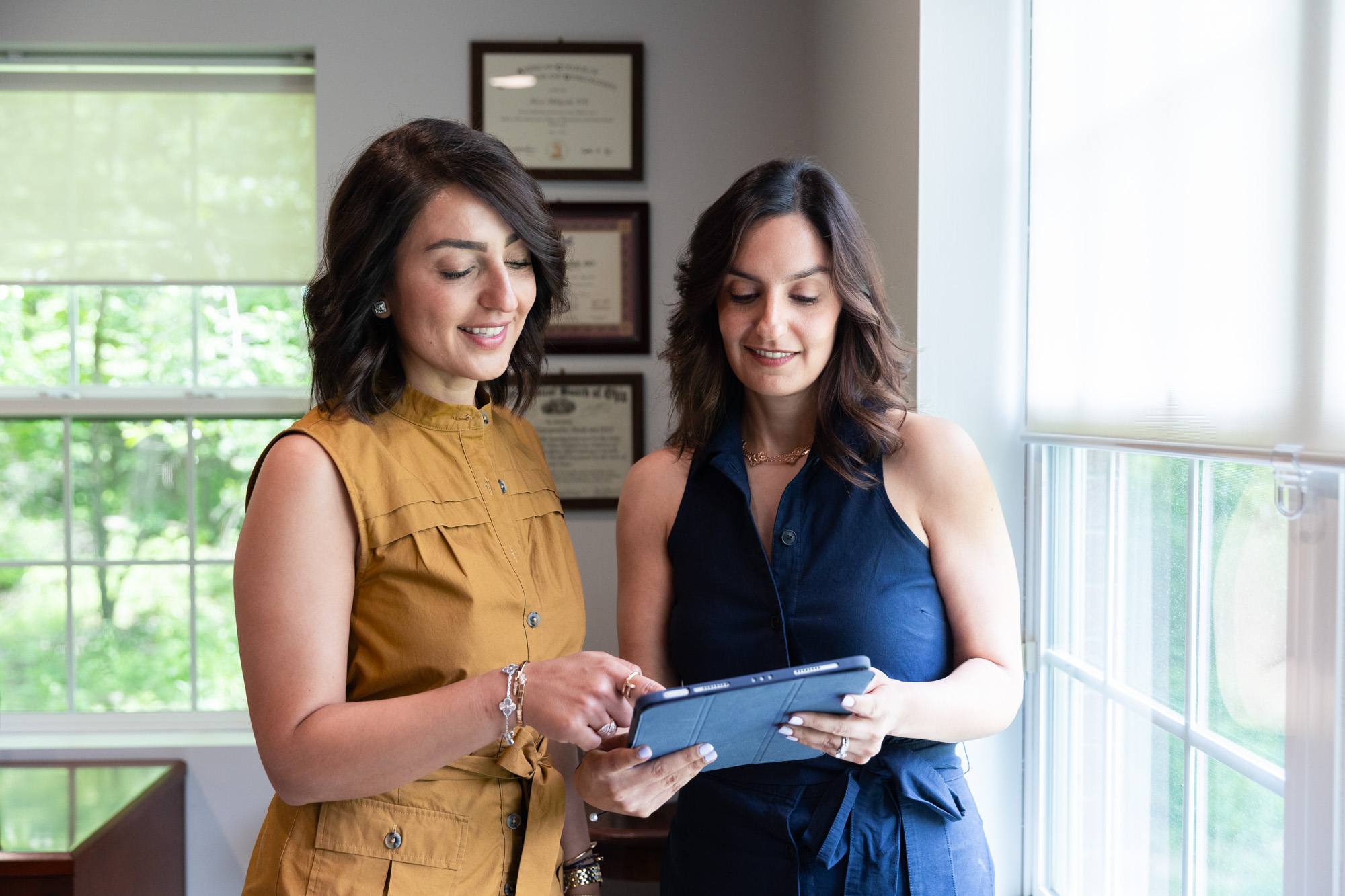 Two female doctors are holding a tablet to discuss a treatment plan for Morpheus8 in Westlake, OH