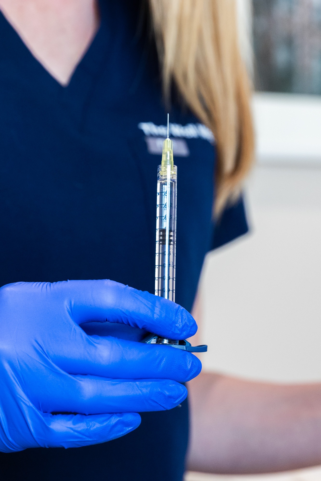 An injector is holding up a syringe of Sculptra in Westlake, OH.