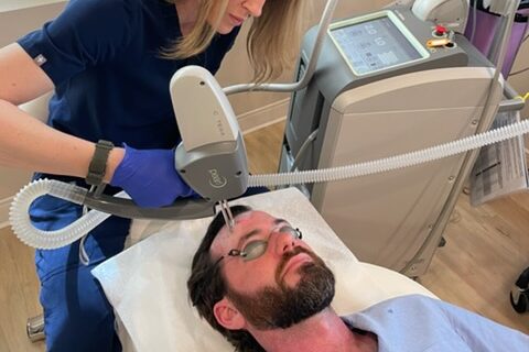 A provider uses the Pearl laser device to administer a patient's skin-tightening treatment in Westlake.