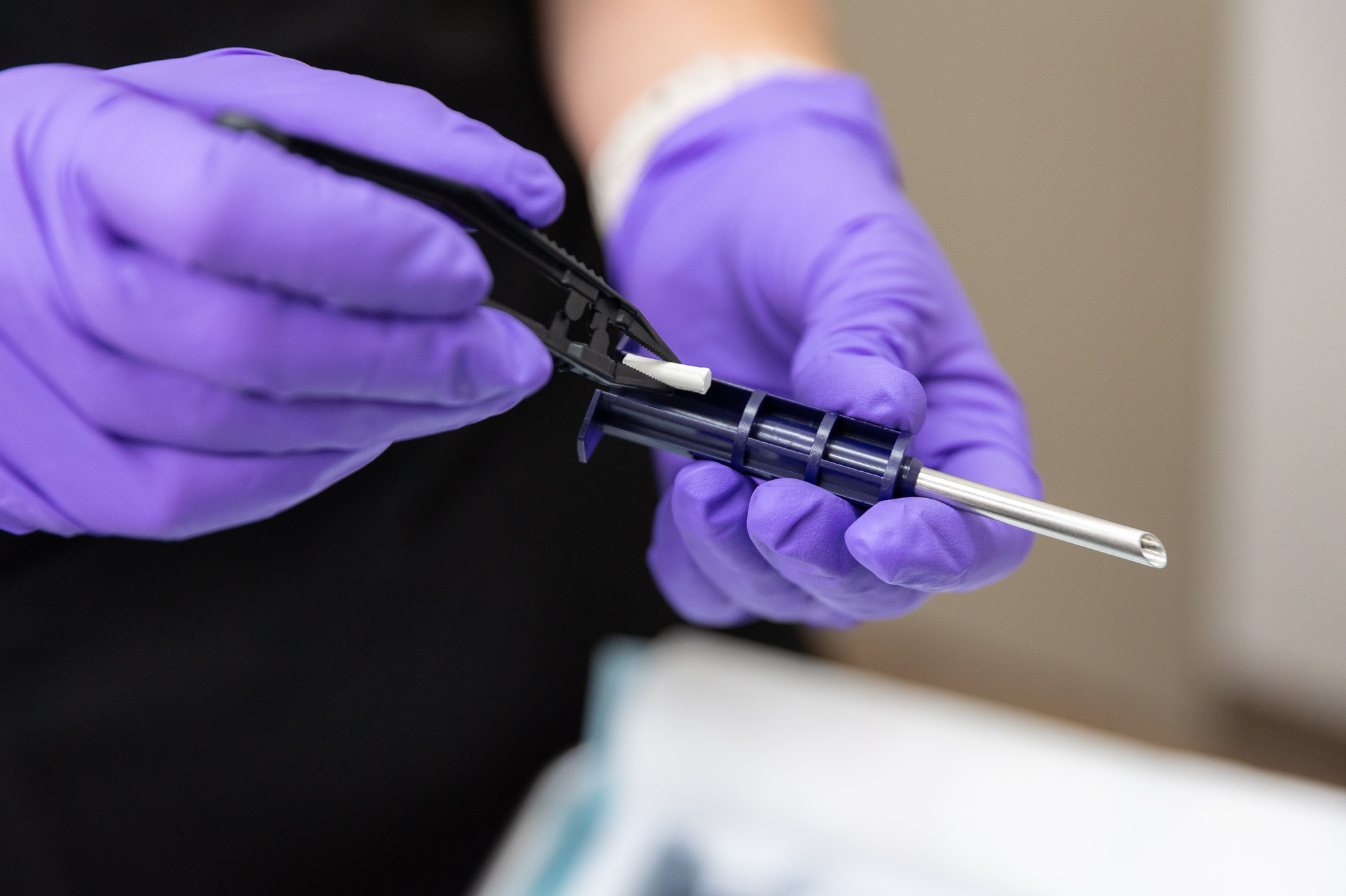  A provider at The Well Westlake prepares a hormone pellet as part of a patient's treatment plan at our wellness clinic near Cleveland.